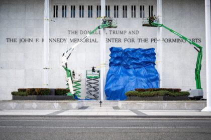 A blue tarp is dropped after the renaming of The John F. Kennedy Memorial Center for the P