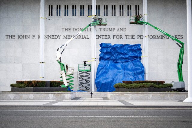 A blue tarp is dropped after the renaming of The John F. Kennedy Memorial Center for the P