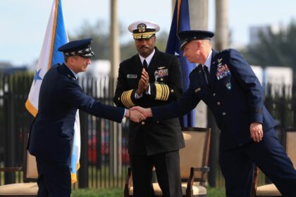 Chairman of the Joint Chiefs of Staff General Dan Caine (L) shakes hands with Air Force Li