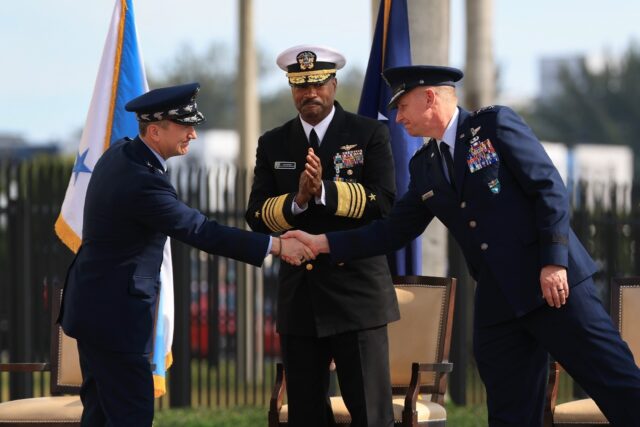 Chairman of the Joint Chiefs of Staff General Dan Caine (L) shakes hands with Air Force Li