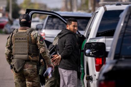 A man being detained during a federal immigration crackdown in New Orleans, Louisiana