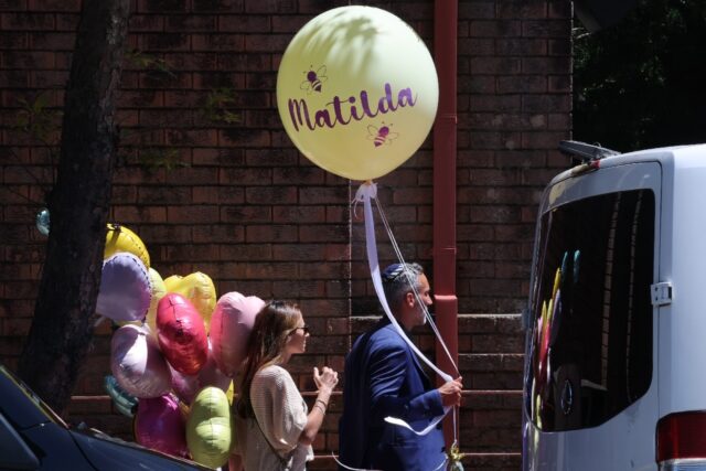 Mourners carry balloons while arriving for the funeral of 10-year-old Matilda, who was kil