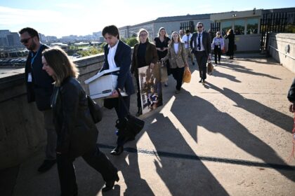 Reporters carry their belongings from the Pentagon on October 15, 2025 after news outlets