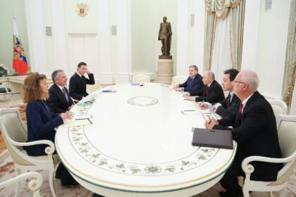 Russia's President Vladimir Putin, accompanied by Kremlin economic envoy Kirill Dmitr