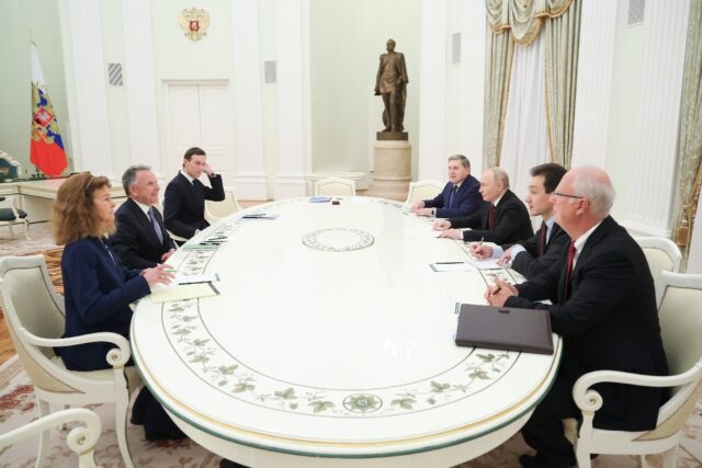 Russia's President Vladimir Putin, accompanied by Kremlin economic envoy Kirill Dmitr