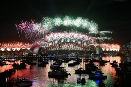 Sydney rang in the New Year with its customary fireworks display after pausing for a minut
