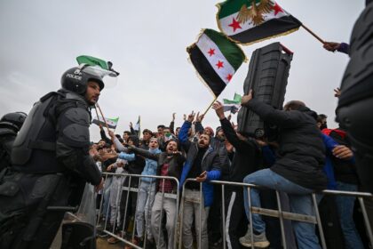Syrians celebrate the anniversary of the toppling of longtime ruler Bashar al-Assad in Dam