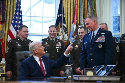 US President Donald Trump speaks with military officers at the White House