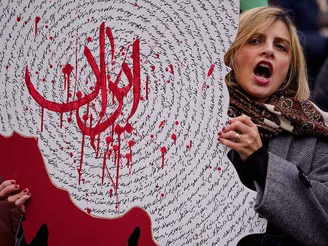 Title: Romania Iran Protests Image ID: 26024608777289 Article: A woman holds a map of Iran