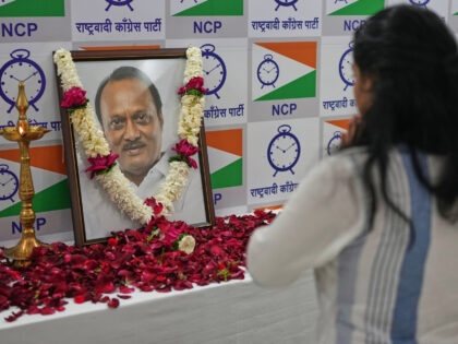 A supporter of Maharashtra Deputy Chief Minister Ajit Pawar pays homage near his photograp