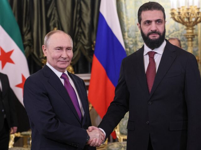 Russian President Vladimir Putin and Syria's President Ahmed al-Sharaa shake hands during