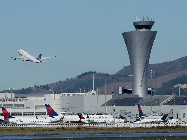 In this Oct. 24, 2107 file photo, the air traffic control tower is in sight as a plane tak