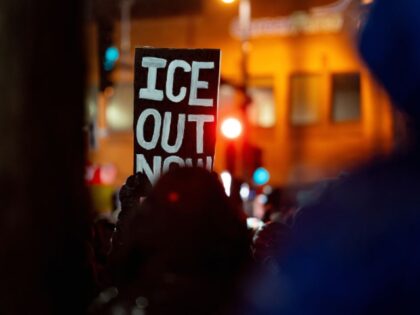 A demonstrator carries a sign during a protest in Minneapolis, Minnesota, US, on Thursday,