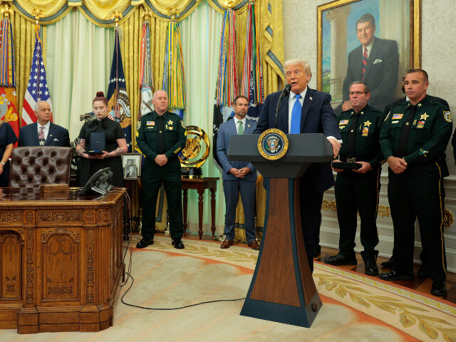Donald Trump with law enforcement officers U.S. President Donald Trump speaks to the loved ones of fallen Palm Beach County Sheriff&#