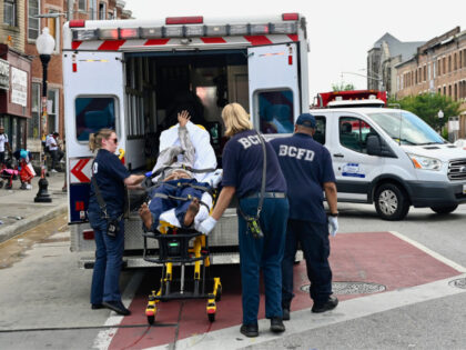 Baltimore City Fire Department paramedics transports another person who collapsed on North