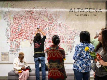 Altadena, CA - January 07:Eaton fire survivors look over a map of homes lost in the fire a