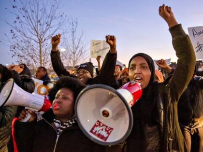 US-LABOUR-PROTEST-AMAZON Demonstrators shout slogans and hold placards during a protest at the Amazon fulfillment c