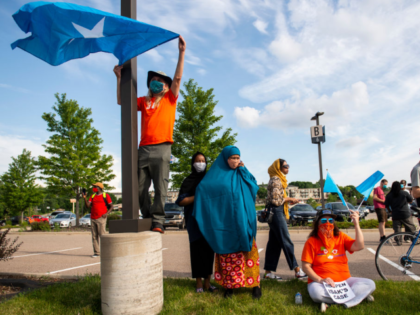 EAGAN, MN - JULY 01: People hold up Somali flags during a protest calling for justice for