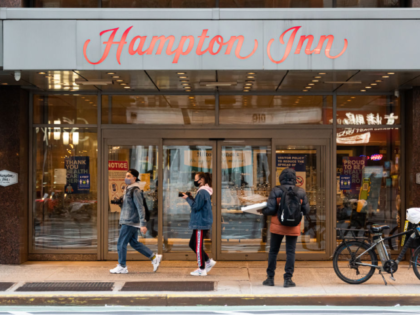 NEW YORK, NEW YORK - MARCH 09: People walk outside the Hampton Inn hotel in Hell's Kitchen