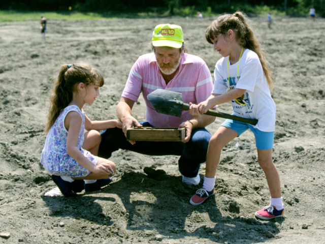 A father and his two daughters dig for real diamonds at Crater of Diamonds State Park near