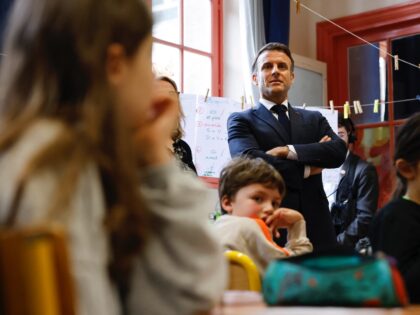 French President Emmanuel Macron meets with Third Grade pupils (CE2) during a visit to the