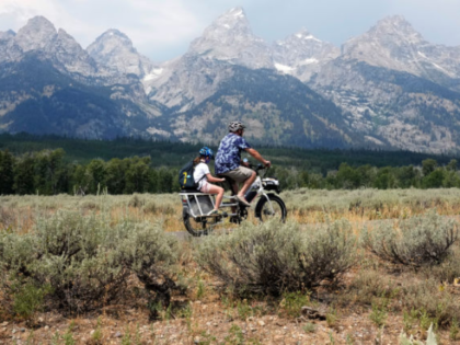 GRAND TETON NATIONAL PARK, WYOMING - AUGUST 9: People ride a bike near Jenny Lake on Augus