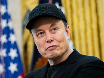 Elon Musk looks on during a news conference with US President Donald Trump in the Oval Off