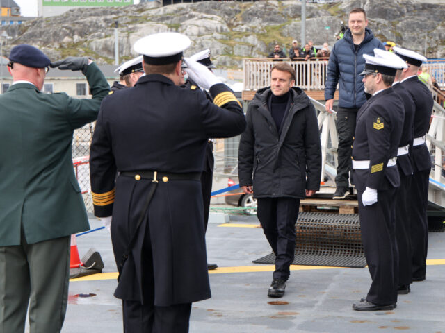 French President Emmanuel Macron (C) is welcomed onboard the Danish frigate F363 Niels Jue