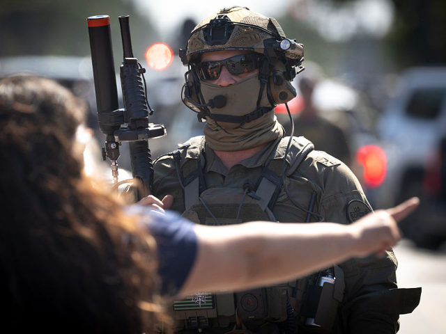 CHICAGO, ILLINOIS - OCTOBER 04: Federal law enforcement agents stand guard as they are con