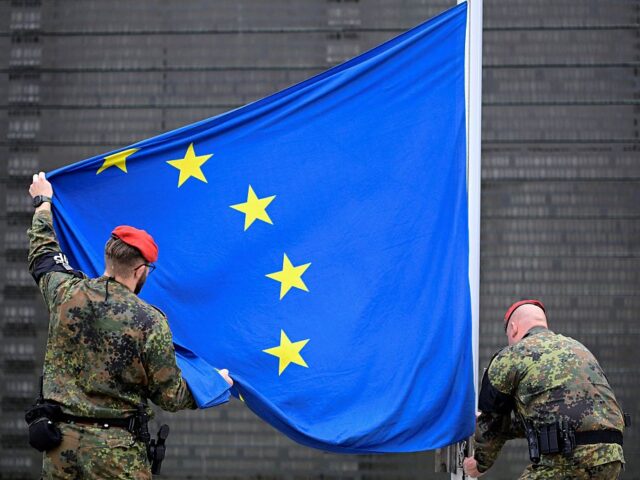 GERMANY-US-POLITICS-DEFENCE-HISTORY-VETERANS Soldiers of the German armed forces Bundeswehr hoist a European flag in front of the Bunde