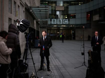 A television crew report from outside the entrance to the offices of British broadcaster B