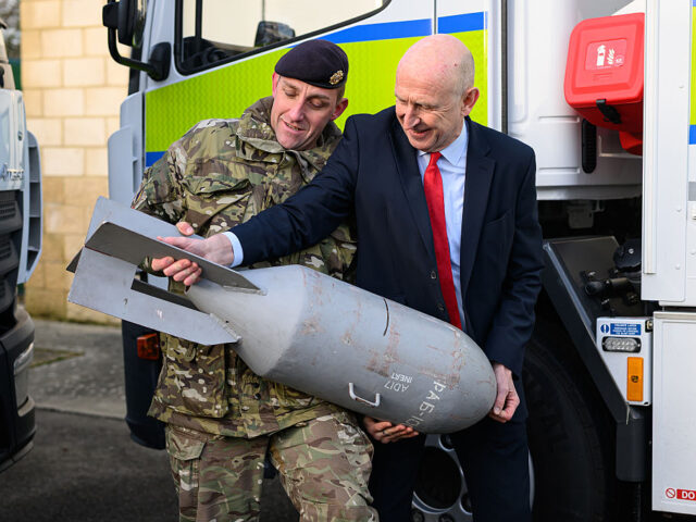 COLCHESTER, ENGLAND - DECEMBER 19: Britain's Defence Secretary John Healey (R) handle