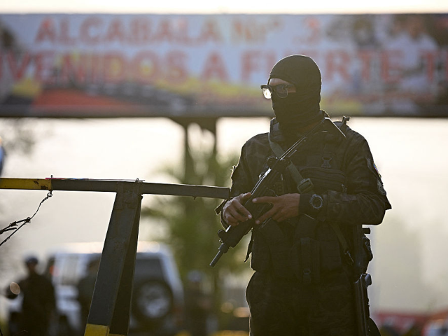A member the National Guard stands guard at an entrance to Fuerte Tiuna, Venezuela's large