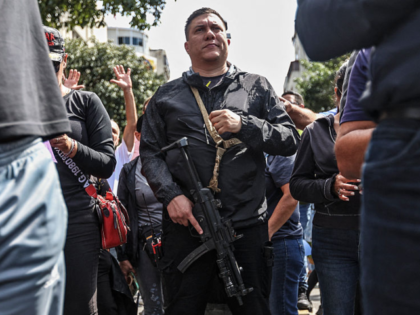 TOPSHOT - An armed supporter of Venezuela's President Nicolas Maduro is seen on a street i