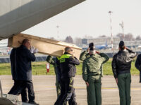 An Italian Air Force C30J military aircraft transports the coffins containing the bodies o