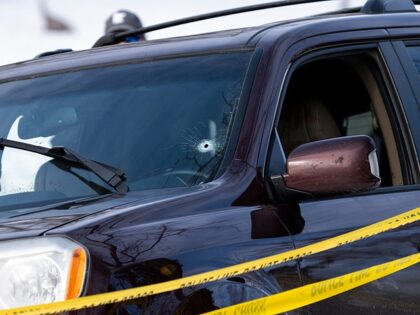MINNEAPOLIS, MINNESOTA - JANUARY 07: A bullet hole is seen in the windshield of a vehicle