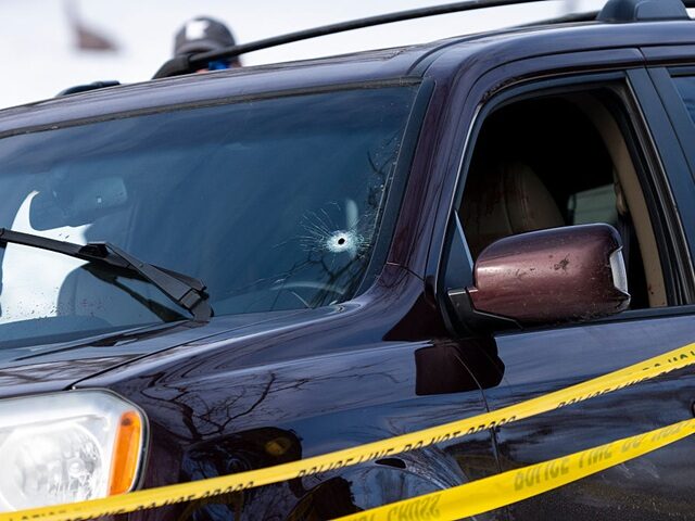 MINNEAPOLIS, MINNESOTA - JANUARY 07: A bullet hole is seen in the windshield of a vehicle