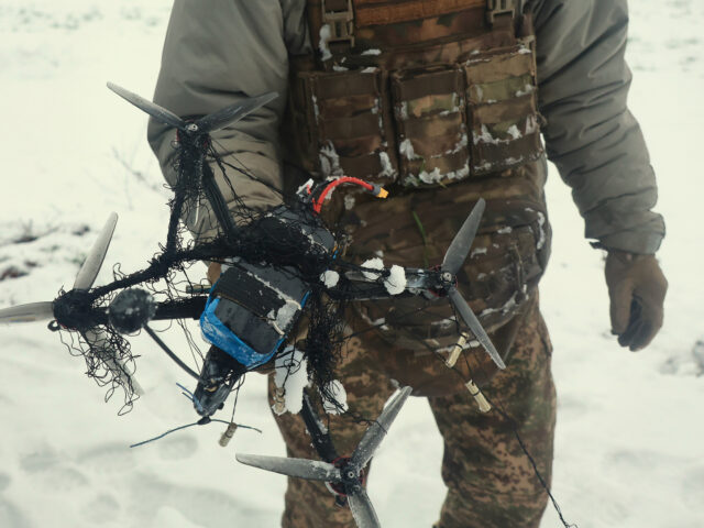 A soldier from the 13th Khartiia Brigade of Ukraine's National Guard shows an FPV drone ta