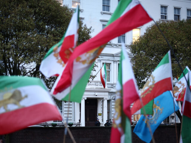 Anti-Iranian regime protesters wave the Iranian flag before the 1979 revolution with the L