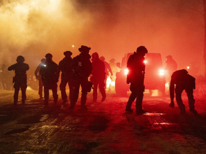 MINNEAPOLIS, MINNESOTA, US. - JANUARY 14: Federal agents deploy tear gas and pepper balls