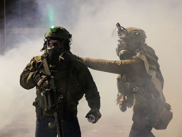 MINNESOTA, UNITED STATES - JANUARY 14: Federal agents deploy tear gas as residents protest