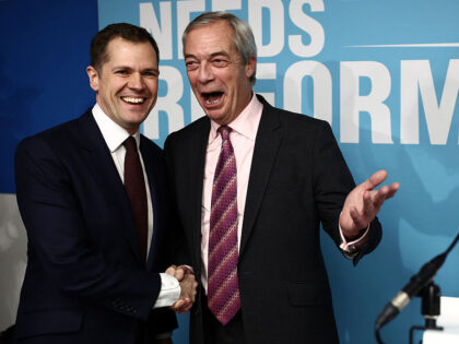 Britain's former Conservative Party Shadow Justice Secretary Robert Jenrick shakes ha