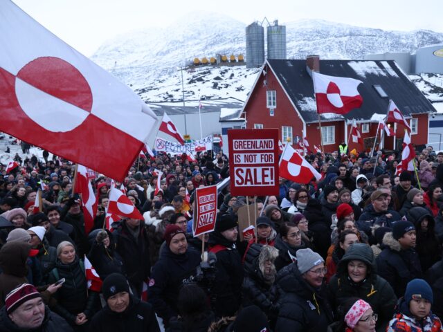 NUUK, GREENLAND - JANUARY 17: People hold Greenlandic flags and placards as they gather by
