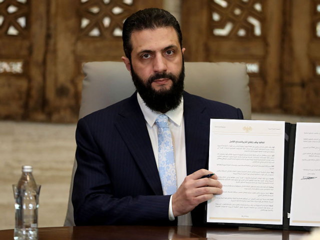 GettyImages-2256346165 DAMASCUS, SYRIA - JANUARY 18: Syrian President Ahmed Al-Sharaa speaks to media as he signs