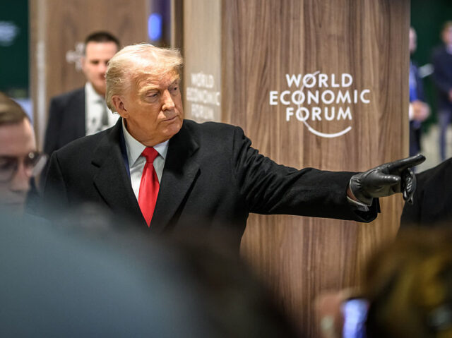 US President Donald Trump gestures as he leaves the congress centre during the World Econo