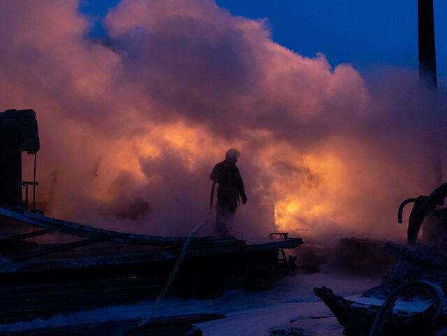 KYIV, UKRAINE - JANUARY 24: Rescuers extinguish a fire at a garage compound in the Darnyts