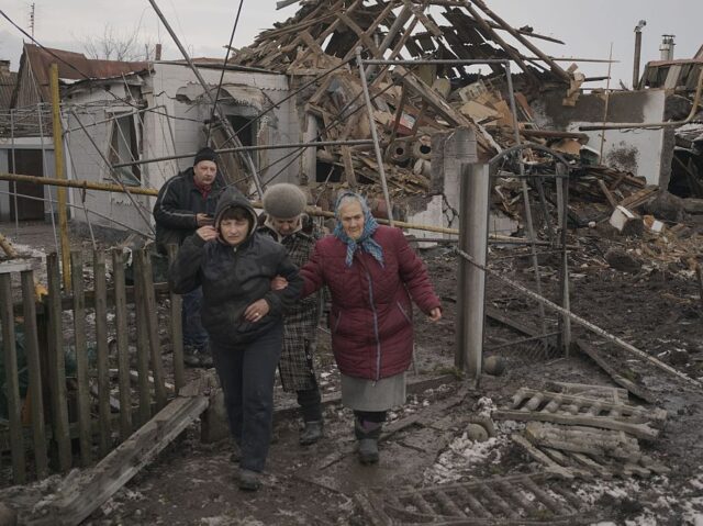 VILNYANSK, ZAPORIZHIA, UKRAINE - JANUARY 29: Citizens move away from homes that were damag