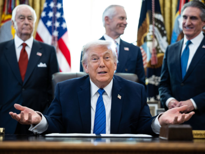US President Donald Trump, second left, speaks during an executive order signing in the Ov