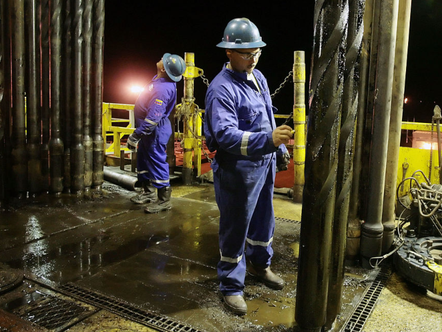 VENEZUELA - SEPTEMBER 18: Workers of Nabors Industries Ltd. mark drill pieces on a drillin