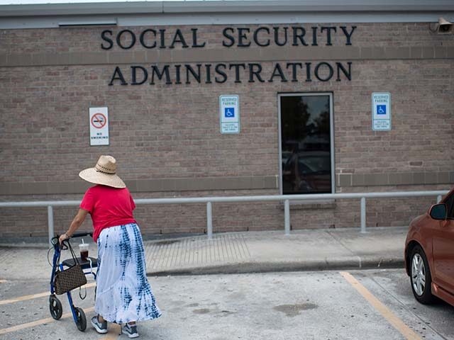 A woman walks into a Social Security office in Houston, Texas on July 13, 2022. (Photo by